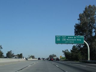 The next exit along California 99 north is Exit 26A, California 58 west and California 178 east (one mile). This exit is in the northwestern portion of Bakersfield. This marks the western terminus of California 178, the only state highway to cross the Sierra Nevada between California 58 and California 120. Although other such crossings between Yosemite and Lake Isabella were planned in the heyday of highway construction (for example, see the unconstructed segments of California 168, California 180, and California 190 that would have crossed the high mountains), none were constructed as state routes. California 178 continues east into Death Valley National Park (with a route break in the park east of Trona), and it ultimately matches up with Nevada 372. Prior to 1964, California 58 west of California 99 (U.S. 99) was known as California 178, but that changed when U.S. 466 was decommissioned.