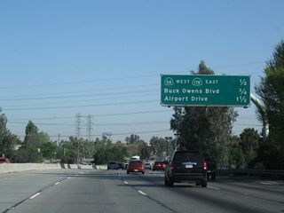 This mileage sign along California 99 (Golden State Highway) north provides the distance to the next three exits: Exit 26A, California 58 west and California 178 east; Exit 26B, Buck Owens Boulevard; and Exit 27, Airport Drive. Currently, California 58 is a city street and rural road west of here. Traffic demands have indicated that an east-west freeway would be needed between California 99 and Interstate 5; construction of the Westside Parkway began in summer 2009 and is expected for completion in spring 2012 between Allen Road in the west and Truxtun Avenue in the east (just shy of California 99). In future phases, the Westside Parkway is planned for eventual connections to Stockdale Highway (and possibly Interstate 5) to the west.