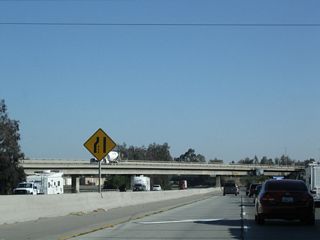 Passing through the Airport Drive interchange, a flyover ramp connects Airport Drive south with California 99 south.