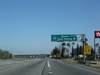 Northbound California 99 meets Exit 44, California 46 (Famoso Highway) west. A major east-west state route, California 46 crosses the Central Valley generally along the alignment of Historic U.S. 466, which was decommissioned in 1964. In addition to serving the Central Coast, California 46 will meet Interstate 5 in Lost Hills, then continues across the Cholame Hills before meeting U.S. 101 at Paso Robles. After a brief merge with U.S. 101, California 46 makes the final jog to meet California 1 at the coast. The exit eastbound connects to locally maintained Famoso-Woody Road, connecting to California 155 to the northeast at Woody.