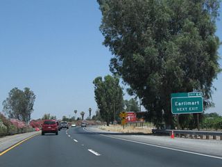 Earlimart is an unincorporated community of Tulare County, with a population of 8,537 as of the 2010 Census. Use Exit 64 to State Street north through Earlimart. Front Street is old U.S. 99, not State Street. Near as we can tell, Earlimart may have had a California 99 Business designation via Front Street.