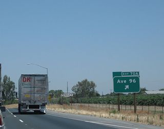 Exit 70A departs from SR 99 north for CR J-24 (Terra Bella Avenue). Historic U.S. 99 has a very short segment on the west side of the freeway along Main Street that passes through downtown Pixley. It will rejoin the freeway at Exit 71. Main Street may had been signed as a business route at one time, but no signs remained as of 2010.
