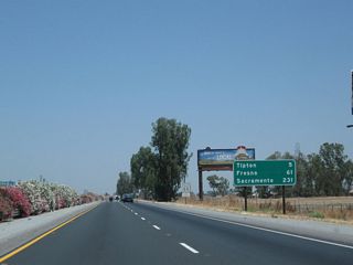 This mileage sign along California 99 (Golden State Highway) north provides the distance to Tipton (five miles), Fresno (61 miles), and Sacramento (231 miles).
