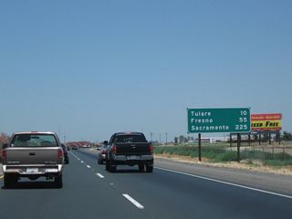 This mileage sign along California 99 (Golden State Highway) north provides the distance to Tulare (10 miles), Fresno (55 miles), and Sacramento (225 miles).