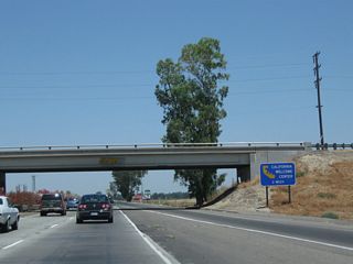 California 99 passes under Avenue 184. A California Welcome Center is located at the International Agri-Center. The next exit (Exit 83, Avenue 200) serves both the Agri-Center and the Welcome Center. Tourist information and restrooms are available at the welcome center during hours of operations (always a good idea to check hours of operation before visiting the center). Overhead, a Southern California Edison power line crosses overhead. Most of Tulare County (including the cities of Tulare and Visalia) are served by Southern California Edison, unlike most other parts of the Central Valley that are served by Pacific Gas and Electric.