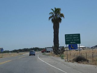 Briefly looking at the loop ramp from California 99 north to Avenue 200, this sign advises a left turn to the International Agri-Center and the Tulare California Welcome Center. Turn right to California 99 Business (K Street) (Historic U.S. 99) north to downtown Tulare.