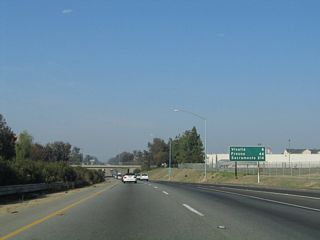 This mileage sign along California 99 north provides the distance to Visalia (eight miles), Fresno (44 miles), and Sacramento (214 miles).