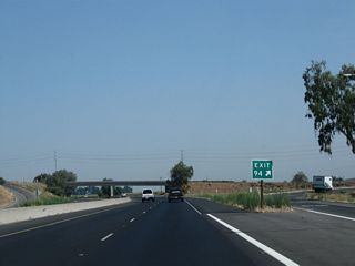 When California began its modern exit numbering program in 2002, some of the first exit numbering signs were posted in Kern and Tulare Counties along California 99 and Interstate 5. By 2009, nearly every sign along California 99 in the southern San Joaquin Valley had been converted to reflective standards with exit numbers on appropriate advance guide signs as well as gore points such as this one at Exit 94 in Tagus.