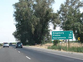 This mileage sign along California 99 (Golden State Highway) north provides the distance to Kingsburg (six miles), Fresno (26 miles), and Sacramento (198 miles). The button copy sign was replaced by a nearly identical ("carbon copy") reflective sign.