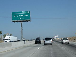 The next exit along California 99 north is Exit 115, Fresno County Route J-40 (Mountain View Avenue). Note the freeway expansion that resulted in an additional left lane through here; it was added between 2004 and 2011.