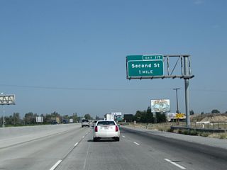 The next exit along California 99 north is Exit 117, Second Street (one mile). This is the first of two interchanges that serve the city of Selma, which is noted on the billboard as being the "Raisin Capital of the World."
