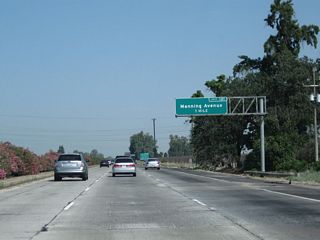 The next exit along California 99 north is Exit 121, Manning Avenue (one mile). This major, east-west county highway crosses the Central Valley and links Interstate 5, California 99, and California 63. The portion of Manning Avenue between Alta Avenue and Hills Valley Road is also designated as part of County Route J-19, which ultimately connects to Orange Cove.