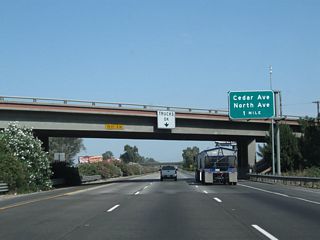 The next exit along California 99 is Exit 128, Cedar Avenue and North Avenue. This interchange consists of two half-diamond interchanges: one half-diamond with north-south Cedar Avenue (Exit 128 northbound) and another half-diamond with east-west North Avenue (southbound's Exit 129). Exiting traffic from northbound will connect directly to Cedar Avenue, with a right turn onto Cedar Avenue north to reach North Avenue.