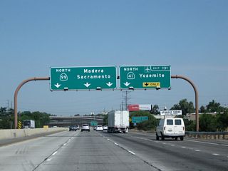 Now at one of its widest points in the vicinity of Fresno, the three left lanes carry through traffic for northbound California 99 while the two right lanes prepare to exit onto northbound California 41 (Exit 131). This is a major freeway-to-freeway interchange.