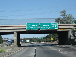 Northbound California 99 reaches Exit 133, California 180 freeway east to Kings Canyon National Park and west to Mendota. By 2004, this interchange was expanded to include a link to California 180 west as well as east. As a result, the signs changed between May 2003 and April 2004 to reflect the connection to California 180 west.
