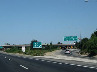 A huge gore point sign for Exit 133 is posted along California 99 north. Once on the ramp, the left lane will link to California 180 west to Kerman and Mendota, while the right lane will connect to California 180 east to Sequoia-Kings Canyon National Park.