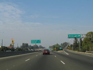 Northbound California 99 meets Exit 135A, Olive Avenue. Motorist services (gas, lodging, and food) are available at this interchange.