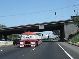 California 99 is known as California's Workhorse Highway due to its role moving goods across the Golden State. Trucks such as this one carrying tomatoes are a common sight in this agricultural region.