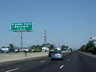 The next exit along California 99 north is Exit 138A, North Golden State Boulevard as we pass a tall tower advertising "GAS." North Golden State Boulevard is old U.S. 99; it parallels the freeway to the east between Exit 138A and Exit 143 (Herndon Avenue).