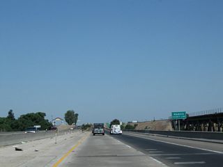 Near the midpoint of the San Joaquin River bridge, California 99 and the Burlington Northern Santa Fe (BNSF) Railroad leave Fresno County and enter Madera County (population 150,865 as of 2010 Census).