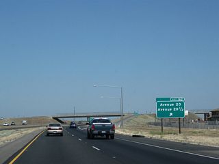 Northbound California 99 reaches Exit 162, Avenue 20 and Avenue 20 1/2 in rural Madera County.