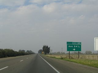 This sharp right turn connects northbound California 99 to Exit 168, Avenue 24 1/2. Chowchilla, announced in the billboard, is the next city of significance along northbound.