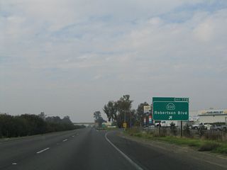 Northbound California 99 (Golden State Highway) meets Exit 170, California 233 (Robertson Boulevard) southwest to Chowchilla and Avenue 26 east. California 233 leads southwest through Chowchilla to join California 152 a few miles west of here. The exit number sign was added here in early 2003.