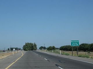 The next intersection along California 99 north is Buchanan Hollow Road east, which provides local farm and ranch access.