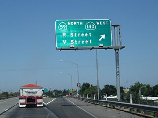 Northbound California 99 meets Exit 188, 13th Street to R Street, California 59 (V Street) north, and California 140 (McSwain Road) west. California 59 leads north to Snelling, and changes into Merced County Route J-59 after passing the Snelling Courthouse State Historic Monument and Merced County Route J-16. This is the location of the proposed Eastside Freeway (California 65). Merced County Route J-59 continues as Tuolumne County J-59 to terminate at California 108-120 west of Sonora. California 140, meanwhile, leads west via McSwain Road to serve Stevinson and Gustine before ending at Interstate 5. Photo taken 07/31/11).