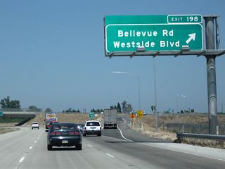 Northbound California 99 reaches Exit 198, Bellevue Avenue east and Merced County Route J-18 (Westside Boulevard) west. To Olive Avenue and Stein Avenue, use Bellevue Avenue east. Olive Avenue serves as the eastern frontage road as California 99 continues northwest (Olive Avenue changes into Campbell Boulevard northeast of here).