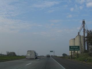 The grain elevator to the east of California 99 indicates how agricultural the Central Valley is. Use Collier Avenue to the unincorporated community of Hilmar.