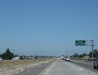 The next two exits along California 99 north serve the unincorporated community of Delhi in Merced County: Exit 205, South Avenue and Exit 207, Shanks Road.