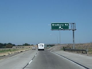 Northbound California 99 meets Exit 208, Bradbury Road. Bradbury Road leads east-west, with westbound entering Stanislaus County near its junction with California 165. Heading east, it connects to Merced County Route J-7 (Santa Fe Drive).