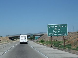 The next exit along California 99 (Golden State Highway) north is Exit 209, California 99 Business (Golden State Boulevard) north into the city of Turlock (0.50 mile). Along a route laden with business routes, many are poorly or unsigned from California 99. The Turlock business loop, which serves the city of Turlock (located in Stanislaus County) begins at Exit 209 and is well-signed (by California standards) from northbound California 99. The loop follows aptly named Golden State Boulevard.