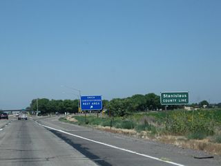 Northbound California 99 (Golden State Highway) enters Stanislaus County and reaches Exit 210, Enoch Christoffersen Safety Rest Area, which include restrooms, pet walking area, parking, and related facilities.