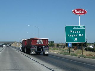 Northbound California 99 meets Exit 218, Keyes Road.