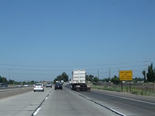 Through traffic is advised to use the left lanes of California 99 north for the next 14 miles as we approach the cities of Ceres and Modesto.