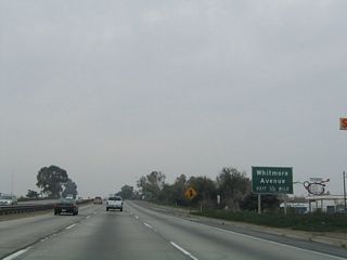 The next exit along California 99 north is Exit 222, Whitmore Avenue. A major east-west arterial, Whitmore Avenue connects with Carpenter Road in the west and Stanislaus County Route J-9 (Hickman Road) in the east. Paralleling the Tuolumne River, it serves the community of Hughson. Exit 222 connects northbound with Whitmore Avenue.