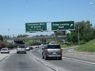 Northbound California 99 reaches Exit 225A, Crows Landing Road. The next exit along California 99 north is Exit 225B, Tuolumne Boulevard and B Street.