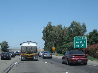Northbound California 99 reaches Exit 240, Austin Road.
