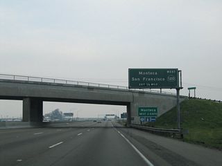 The next exit along California 99 north is Exit 241, California 120 west to Manteca, Tracy, Livermore, Dublin, Hayward, Oakland, and San Francisco. California 120 only makes it as far west as Manteca; the route does not directly serve the other locations leading into the Bay Area. San Francisco is reached via a combination of California 120, Interstate 205, Interstate 580, and Interstate 80. Use Exit 242 for California 120 east to Sonora.