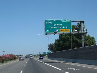 Northbound California 99 reaches Exit 242, California 120 (Yosemite Avenue) east to Oakdale and Sonora and west to downtown Manteca.