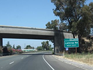 The next exit along California 99 north is Exit 244B, Lathrop Road, next right. Note the use of exit numbers on this series of new signs.