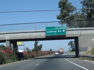 Northbound California 99 meets Exit 244B, Lathrop Road. Lathrop Road leads west to Lathrop and Interstate 5; it leads east to Austin Road.