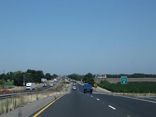 Northbound California 99 reaches Exit 246, San Joaquin County Route J-9 (French Camp Road). A nice view looks north along the 99 freeway.