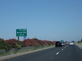 The next exit along California 99 north is Exit 250, Arch Road, one mile. This is a single-point urban interchange (one of the few along California 99), and it is the first to serve the city of Stockton. Interchange improvements were completed here in 2003-2004.