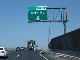 Northbound California 99 meets Exit 250 to Arch Road.