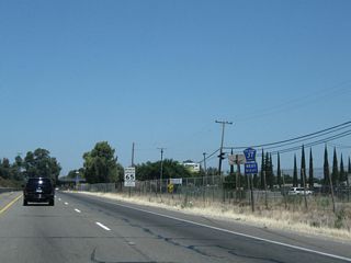 This advance marker for San Joaquin County Route J-7 is a standard advance shield, placed separately from the overhead guide sign.