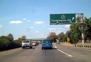 Immediately thereafter, northbound California 99 meets Exit 252B, California 4 (Farmington Road) east to Farmington, Copperopolis, Angels Camp, Murphys, and Arnold. California 4 Business (Farmington Road) (which was signed in 2003 but appears to be unsigned as of 2011) travels west from this interchange to meet Mariposa Road.