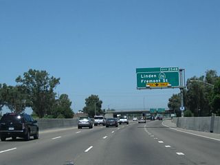 The right lane of California 99 north becomes exit only for Exit 254C, California 26 (Fremont Street). This second exit allows traffic from California 4 east to access California 26 east. This interchange serves as the western end of California 26. Fremont Street west of here is not part of the state highway system. Fremont Street enters the city center of Stockton, connecting to California 99 Business near downtown.